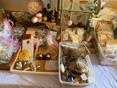 Sale Photo Thumbnail #70: Collection of vintage estate sale items featuring hardware, glass door knobs, opera glasses, printed ephemera, and decorative collectibles.
