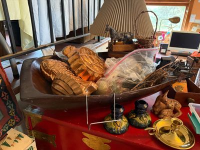 Sale Photo Thumbnail #127: Vintage dough bowl filled with copper-toned gelatin molds and decor, displayed alongside ceramic candlesticks and a carved deer figurine.