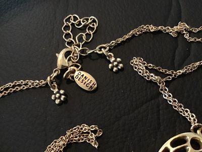 Sale Photo Thumbnail #37: Statement necklace featuring a large openwork butterfly focal piece adorned with red rhinestones and hanging chain fringe with rhinestone drops. Marked 'PILGRIM' on the back of the butterfly and 'DANISH DESIGN' on the metal tag near the clasp. Features a 