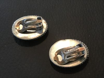 Sale Photo Thumbnail #116: Pair of vintage oval micro mosaic clip-on earrings featuring a detailed colorful floral design set in silver-tone metal frames with rope border details. Stamped 'ITALY' on the back. Clip-on backs function properly. Shows minor vintage wear and patina cons