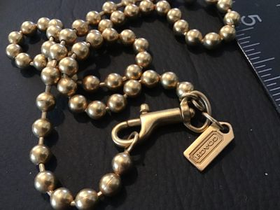 Sale Photo Thumbnail #73: Authentic Coach brass ball bead chain featuring a brass trigger snap hook and a stamped metal 'COACH' hangtag charm. Measures approximately 16 inches long end-to-end (doubled over to around 8 inches as shown with ruler). In good vintage pre-owned conditio