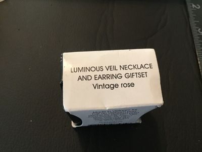 Sale Photo Thumbnail #18: Avon "Luminous Veil" necklace and matching earring gift set in color/style "Vintage rose". Features pink rhinestones set in a gold-tone teardrop pendant with matching stud earrings. Items appear new in original plastic packaging with box.