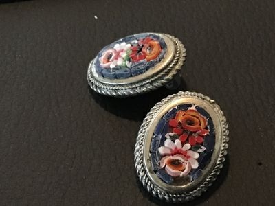 Sale Photo Thumbnail #115: Pair of vintage oval micro mosaic clip-on earrings featuring a detailed colorful floral design set in silver-tone metal frames with rope border details. Stamped 'ITALY' on the back. Clip-on backs function properly. Shows minor vintage wear and patina cons