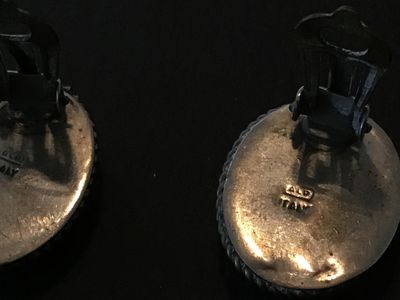 Sale Photo Thumbnail #117: Pair of vintage oval micro mosaic clip-on earrings featuring a detailed colorful floral design set in silver-tone metal frames with rope border details. Stamped 'ITALY' on the back. Clip-on backs function properly. Shows minor vintage wear and patina cons