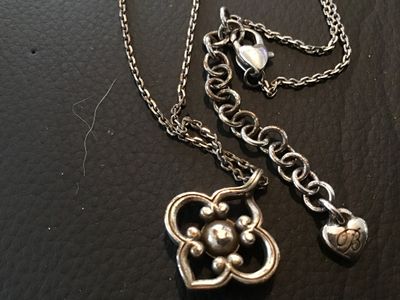 Sale Photo Thumbnail #105: Brighton silver-tone chain necklace featuring a clover/quatrefoil motif pendant set with a central clear crystal stone. Features an adjustable extender chain with the signature Brighton heart tag logo and lobster claw clasp. Pre-owned condition with minor
