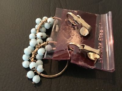 Sale Photo Thumbnail #28: Pair of vintage gold-tone clip-on drop earrings featuring circular hoops wrapped with wire and light blue glass or stone beads along the bottom. Mountings feature clip-on backs. Attached to original retail card labeled 'FASHION EARRINGS'. Pre-owned condit