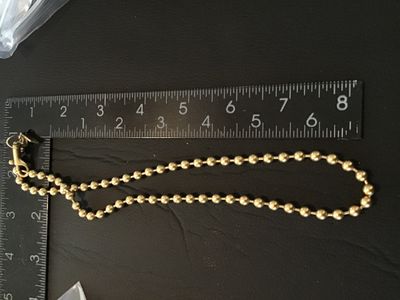 Sale Photo Thumbnail #74: Authentic Coach brass ball bead chain featuring a brass trigger snap hook and a stamped metal 'COACH' hangtag charm. Measures approximately 16 inches long end-to-end (doubled over to around 8 inches as shown with ruler). In good vintage pre-owned conditio