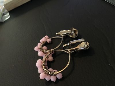Sale Photo Thumbnail #26: Pair of vintage clip-on hoop earrings featuring gold-tone wire wrapped around thin hoops with small cluster-wrapped light pink beads. Clip-on backs are intact. Show light signs of wear consistent with age, but overall in good condition with no missing bea