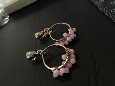 Sale Photo Thumbnail #25: Pair of vintage clip-on hoop earrings featuring gold-tone wire wrapped around thin hoops with small cluster-wrapped light pink beads. Clip-on backs are intact. Show light signs of wear consistent with age, but overall in good condition with no missing bea
