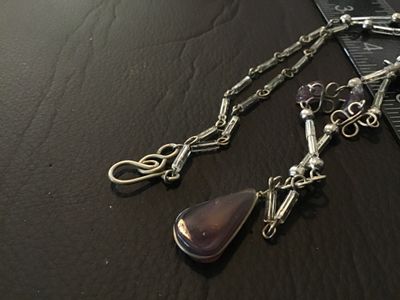 Sale Photo Thumbnail #54: Artisan handmade wire-wrapped necklace featuring purple amethyst chip accents, clear tube beads, silver-tone wire scroll motifs, and a central teardrop agate or amethyst cabochon pendant. Finished with an S-hook clasp. Measures approximately 16-18 inches 