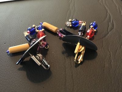 Sale Photo Thumbnail #84: Pair of bold vintage 1980s statement clip-on earrings featuring gold-glitter half-moon tops accented with winged roller skate motifs, dangling colorful multi-bead strands including blue, red, pink, and tan tube beads. Clip-on backs are intact. Measures ap