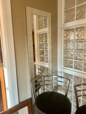 Sale Photo Thumbnail #29: Tall full-length floor mirror featuring a silver mosaic tile frame, shown behind modern metal bar stools.