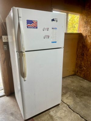 Sale Photo Thumbnail #43: White top-freezer refrigerator adorned with patriotic and business magnets, standing in a garage or workshop.