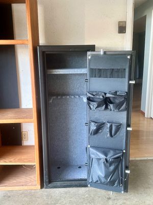 Sale Photo Thumbnail #41: Large black metal gun safe featuring a carpeted interior, adjustable shelving, barrel racks, and door-mounted storage pouches.