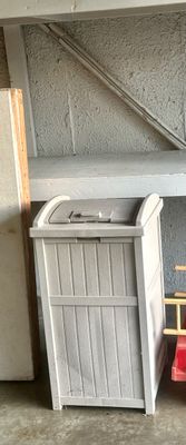 Sale Photo Thumbnail #2: Off-white Suncast resin outdoor trash hideaway with a wainscoting-style design and latching lid.