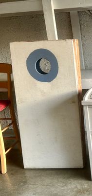 Sale Photo Thumbnail #40: Handmade wooden cornhole board painted white with a blue ring surrounding the hole.