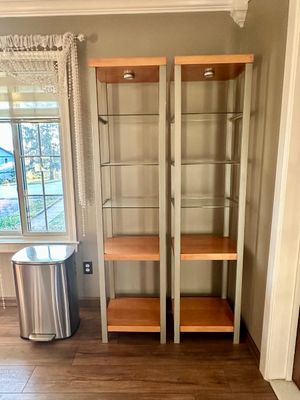 Sale Photo Thumbnail #30: Pair of modern tall display towers with silver metal frames, glass shelves, built-in top lighting, and light wood bases.