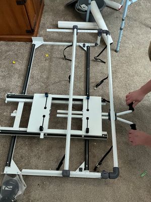 Sale Photo Thumbnail #2: Grace Company metal machine quilting frame resting on a carpeted floor, featuring adjustable tracks and hand cranks.