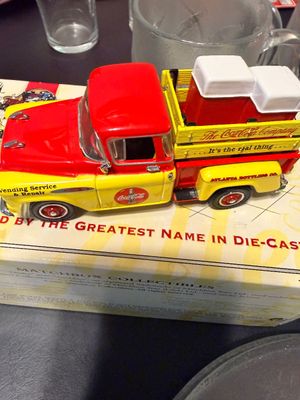 Sale Photo Thumbnail #14: Matchbox Collectibles Coca-Cola die-cast pickup truck carrying vintage vending machine accessories, resting on its original packaging.