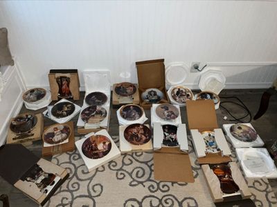 Sale Photo Thumbnail #19: Collection of Norman Rockwell collector plates featuring iconic artwork, mostly housed in original Styrofoam and cardboard packaging.