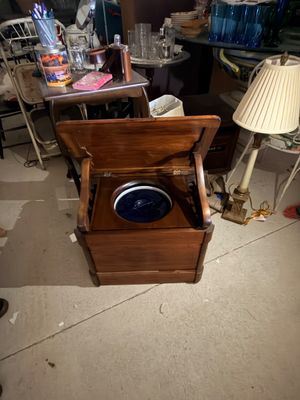 Sale Photo Thumbnail #71: Antique wooden commode chair with a hinged lid revealing a fitted ceramic basin inside.