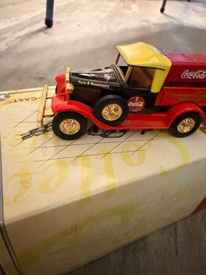 Sale Photo Thumbnail #31: Vintage-style die-cast Coca-Cola Parts & Maintenance delivery truck in red, black, and yellow with gold accents, displayed on its box.