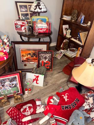Sale Photo Thumbnail #9: Collection of University of Alabama Crimson Tide memorabilia, including framed artwork, lamps, plush toys, glassware, and apparel.