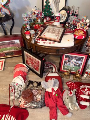 Sale Photo Thumbnail #8: Large collection of University of Alabama Crimson Tide memorabilia, including framed pictures, elephant figurines, plush toys, hats, and a woven throw blanket.