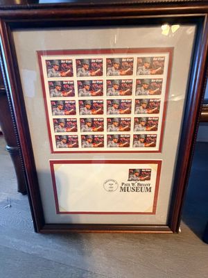 Sale Photo Thumbnail #42: Framed Paul "Bear" Bryant 32-cent USPS stamp sheet and First Day Cover envelope in a dark wood frame.