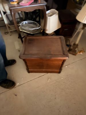 Sale Photo Thumbnail #70: Vintage dark stain wooden storage chest or side table with a hinged top lid, showing minor surface wear.