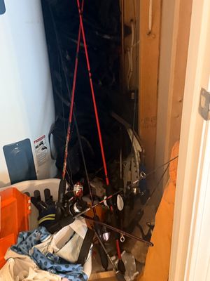Sale Photo Thumbnail #59: Collection of modern fishing rods and reels stored in a utility closet, including spinning rod setups.