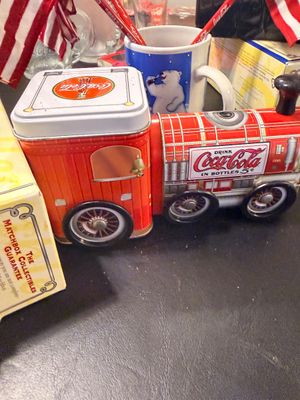 Sale Photo Thumbnail #13: Vintage Coca-Cola collectible train tin set sitting beside a Coca-Cola polar bear coffee mug.
