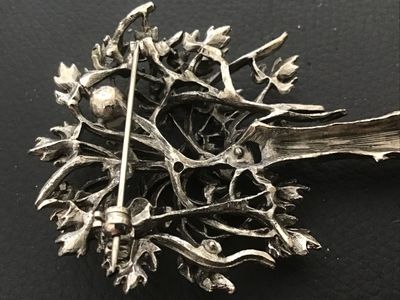 Sale Photo Thumbnail #98: Vintage silver-tone brooch designed in the shape of a tree, featuring detailed foliage with an antiqued or oxidized finish and single faux pearl accent. Includes a rollover safety clasp on the back. Measures approximately 2.25 to 2.5 inches in length. In 