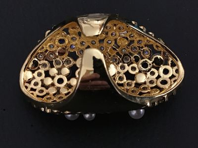 Sale Photo Thumbnail #224: An ornate gold-tone statement ring featuring a cluster of faux pearls, clear rhinestones, and blue accent stones in a lattice/mesh-style setting. An adjustable or open-back band design. Appears in good pre-owned condition with no missing stones visible.