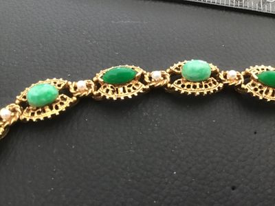 Sale Photo Thumbnail #7: A vintage signed Florenza gold-tone link bracelet featuring alternating oval and marquise-cut faux green jade cabochons, accented with small faux pearls between filigree-style ornate metal links. Measures approximately 7.25 inches in length. Marked 'FLORE