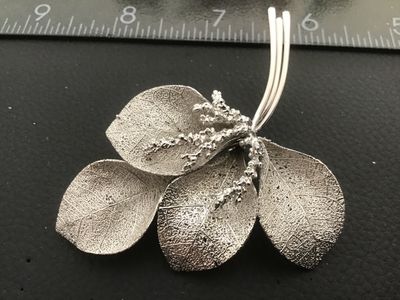 Sale Photo Thumbnail #21: Vintage silver-tone Giovanni brooch featuring an intricate botanical leaf spray design with textured vein details and delicate berry accents. Measures approximately 3 inches in length. Features a secure rollover safety clasp on the back. Stamped with the 