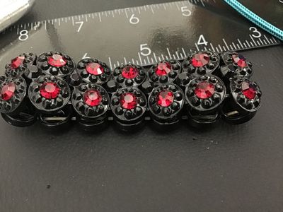 Sale Photo Thumbnail #230: Vintage double-row stretch bracelet featuring black molded plastic round links set with faceted red rhinestones. The bracelet expands for easy wear and features a bold contrast style. Good pre-owned vintage condition with light surface wear.