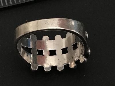 Sale Photo Thumbnail #249: Vintage Native American style / Southwestern sterling silver ring featuring a double row of serrated bezel-set turquoise cabochons (snake eye design) accented with silver raindrops. Stamped STERLING inside the band. Ring measures approximately size 7 on a