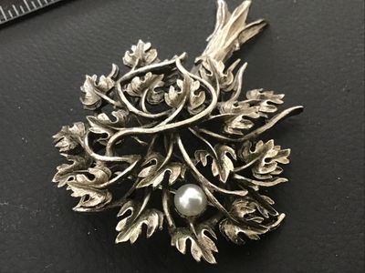 Sale Photo Thumbnail #97: Vintage silver-tone brooch designed in the shape of a tree, featuring detailed foliage with an antiqued or oxidized finish and single faux pearl accent. Includes a rollover safety clasp on the back. Measures approximately 2.25 to 2.5 inches in length. In 