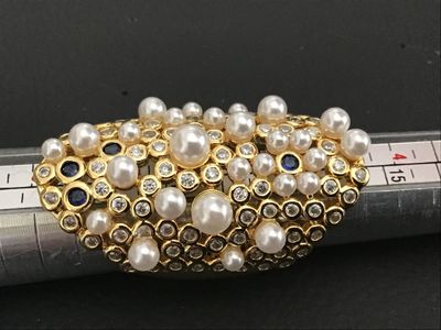 Sale Photo Thumbnail #222: An ornate gold-tone statement ring featuring a cluster of faux pearls, clear rhinestones, and blue accent stones in a lattice/mesh-style setting. An adjustable or open-back band design. Appears in good pre-owned condition with no missing stones visible.