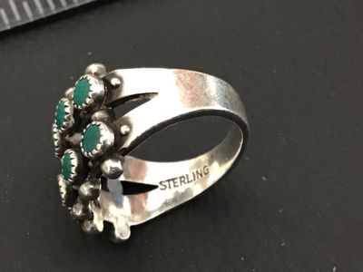 Sale Photo Thumbnail #248: Vintage Native American style / Southwestern sterling silver ring featuring a double row of serrated bezel-set turquoise cabochons (snake eye design) accented with silver raindrops. Stamped STERLING inside the band. Ring measures approximately size 7 on a