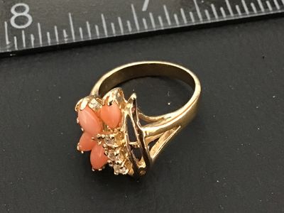 Sale Photo Thumbnail #191: Gold-tone fashion statement ring featuring four marquise-cut coral-pink stones arranged in a floral design, accented with clear round rhinestones. Ring size measures approximately 6 on a ring mandrel. Good condition with light overall wear.