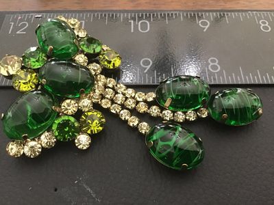 Sale Photo Thumbnail #6: Vintage statement brooch featuring emerald green art glass cabochons with white/swirled inclusions, multi-tone green and light yellow rhinestones, and hanging rhinestones with dangle cabochons. Set in a gold-tone or brass-tone metal mounting with a rollov