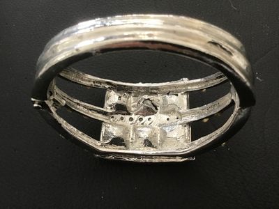Sale Photo Thumbnail #117: Silver-tone metal hinged cuff bracelet featuring six large square-cut yellow/amber faux crystal central stones bordered by smaller amber-colored rhinestones. Features a spring-hinged closure. Good pre-owned condition with minor finish wear to the reverse.
