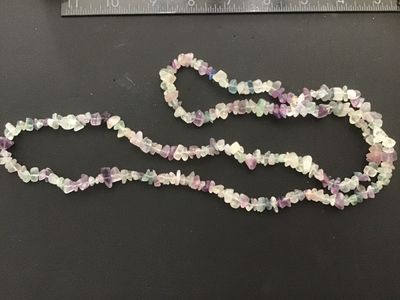 Sale Photo Thumbnail #84: Continuous strand gemstone chip necklace featuring polished natural fluorite chips in shades of purple, green, teal, and clear/white. Measures approximately 32 inches in length. In good pre-owned condition with natural inclusions and variation in the ston