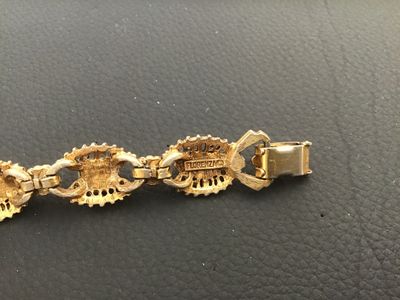 Sale Photo Thumbnail #8: A vintage signed Florenza gold-tone link bracelet featuring alternating oval and marquise-cut faux green jade cabochons, accented with small faux pearls between filigree-style ornate metal links. Measures approximately 7.25 inches in length. Marked 'FLORE