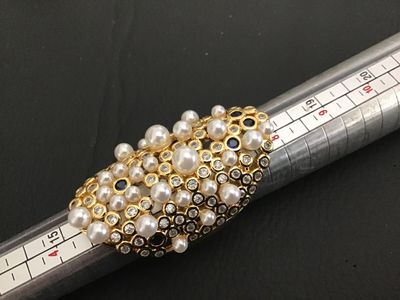 Sale Photo Thumbnail #220: An ornate gold-tone statement ring featuring a cluster of faux pearls, clear rhinestones, and blue accent stones in a lattice/mesh-style setting. An adjustable or open-back band design. Appears in good pre-owned condition with no missing stones visible.