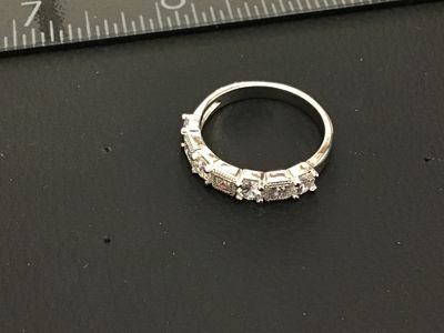 Sale Photo Thumbnail #237: Silver-tone band ring set with five clear cubic zirconia or crystal stones featuring alternating round and square shapes with milgrain border details. Measures approximately size 8 on a ring mandrel. Good condition with minimal wear.
