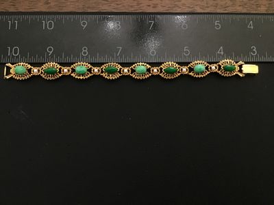Sale Photo Thumbnail #11: A vintage signed Florenza gold-tone link bracelet featuring alternating oval and marquise-cut faux green jade cabochons, accented with small faux pearls between filigree-style ornate metal links. Measures approximately 7.25 inches in length. Marked 'FLORE