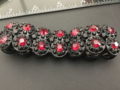 Sale Photo Thumbnail #228: Vintage double-row stretch bracelet featuring black molded plastic round links set with faceted red rhinestones. The bracelet expands for easy wear and features a bold contrast style. Good pre-owned vintage condition with light surface wear.